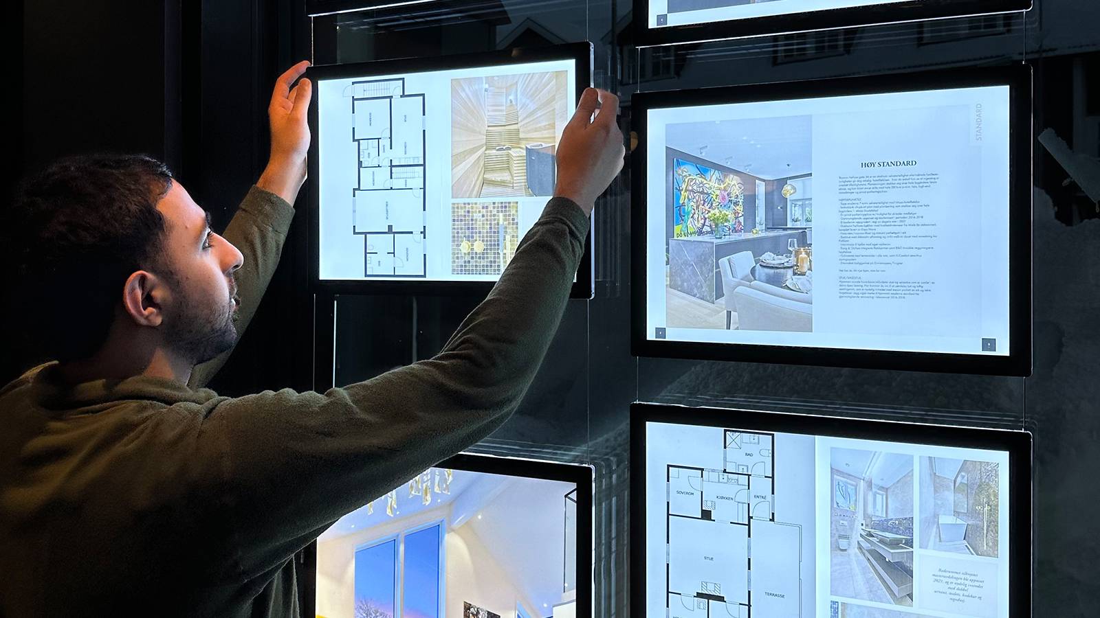 en man fills LED panels with housing offer images