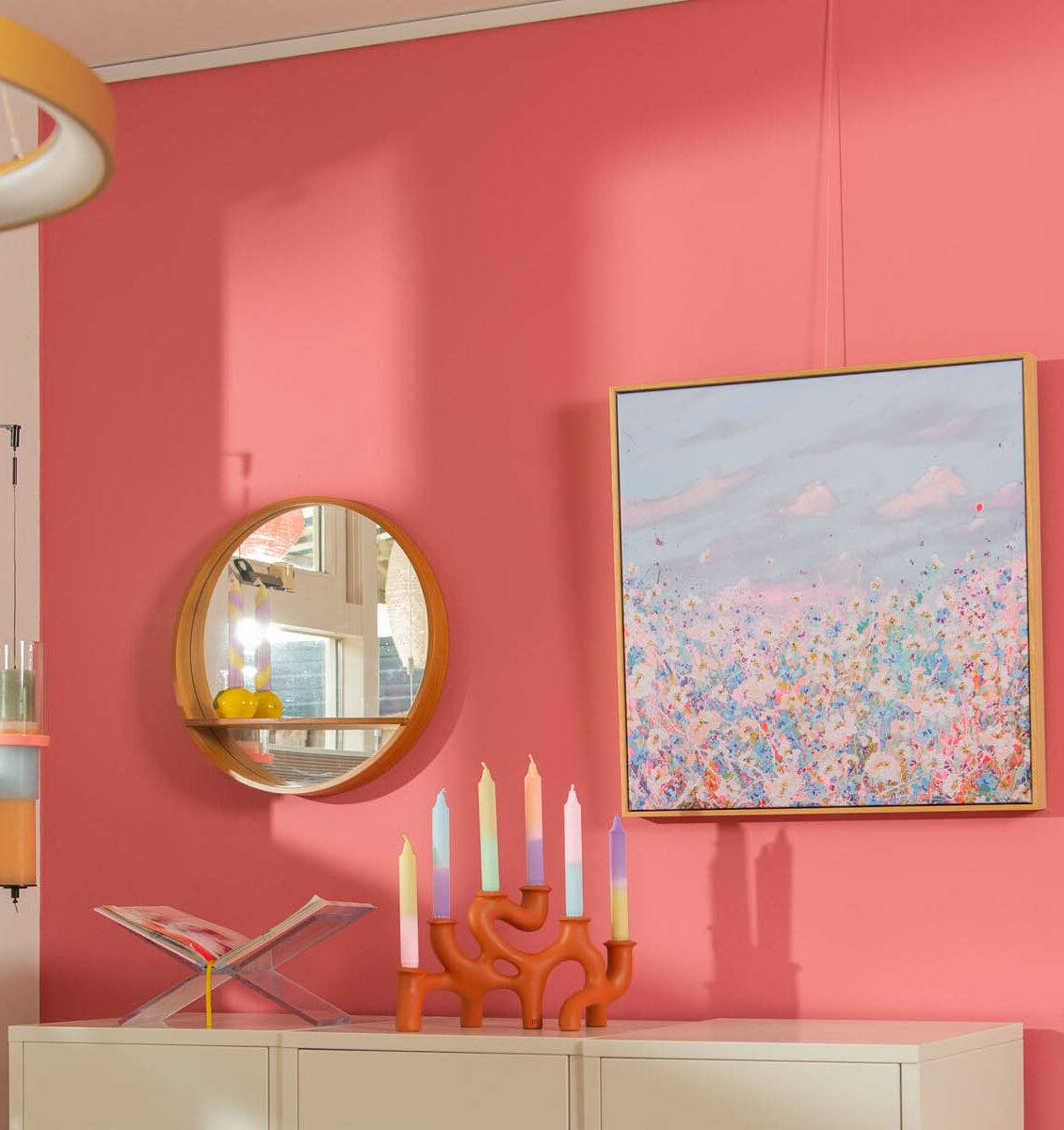 NL roze wand met daaraan een gerecyclede spiegel en een kunstwerk