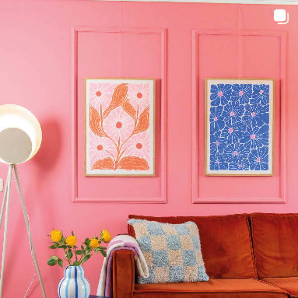 roze muur met 2 kleurrijke posters