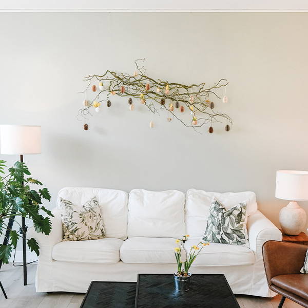 EN branch above white couch on wall